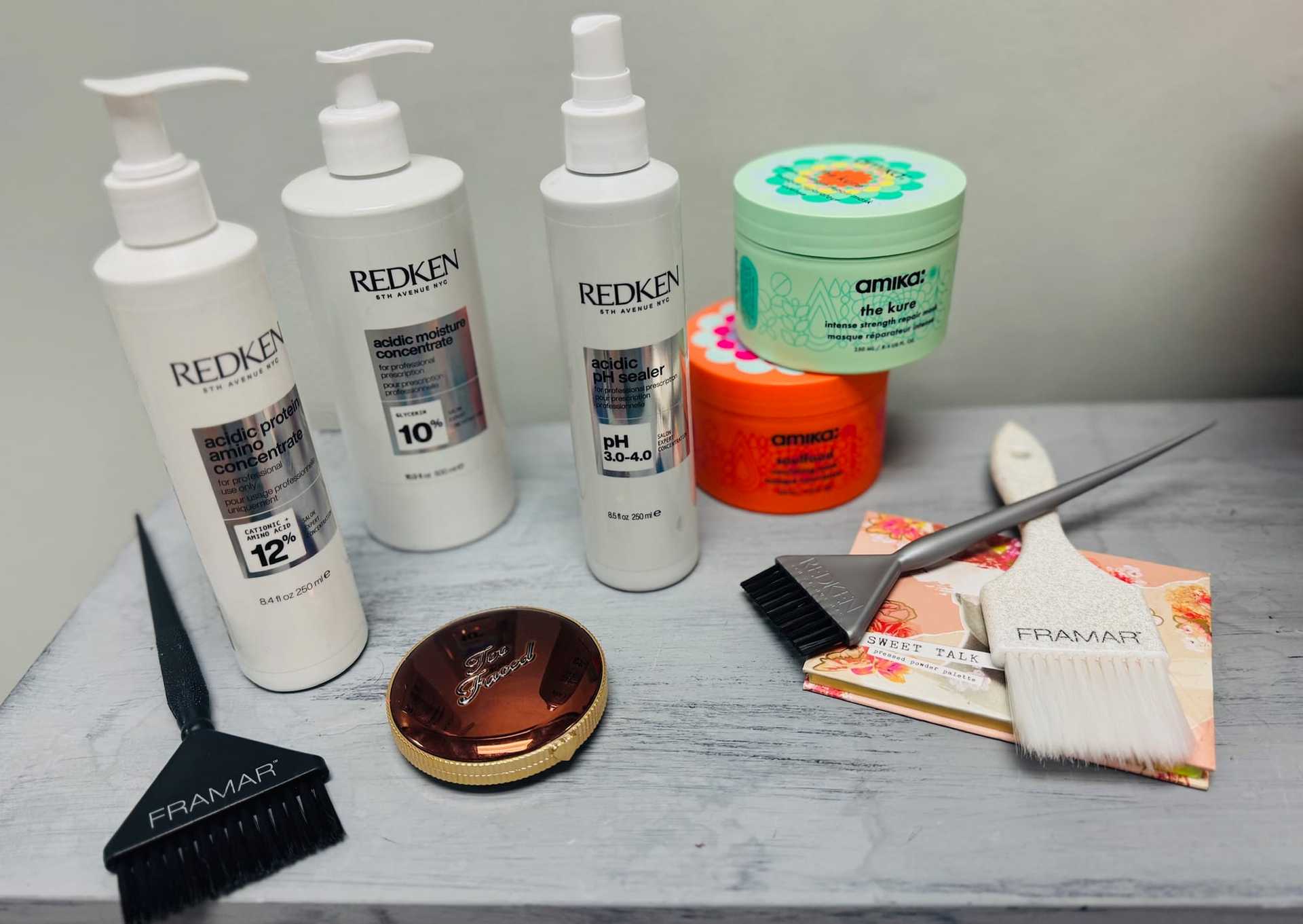 Hair care products and styling tools displayed on a shelf.